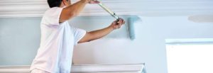 man roller painting
